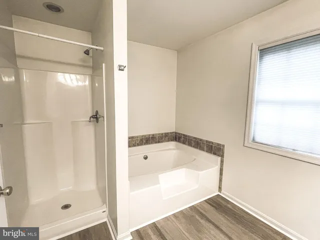 a bathroom with a sink toilet tub and shower