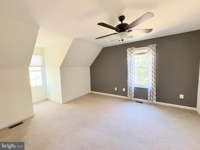 an empty room with a empty space and a ceiling fan