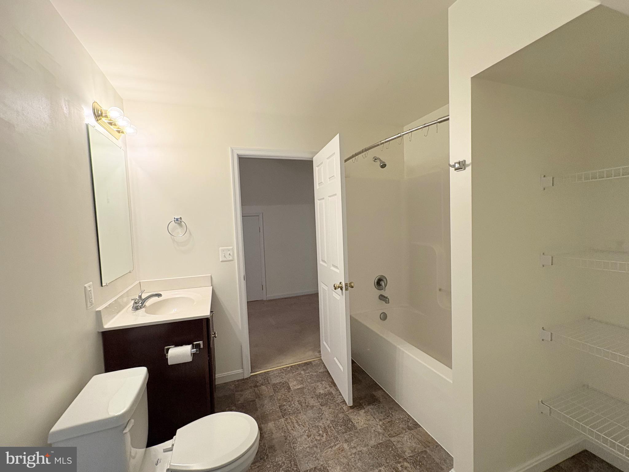 18162 White Tail Way St. Inigoes, MD 20684 - Photo 20 of 29 a bathroom with a sink toilet tub and shower
