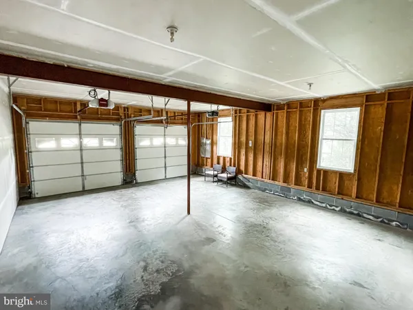 an empty room with sliding door and wooden floor