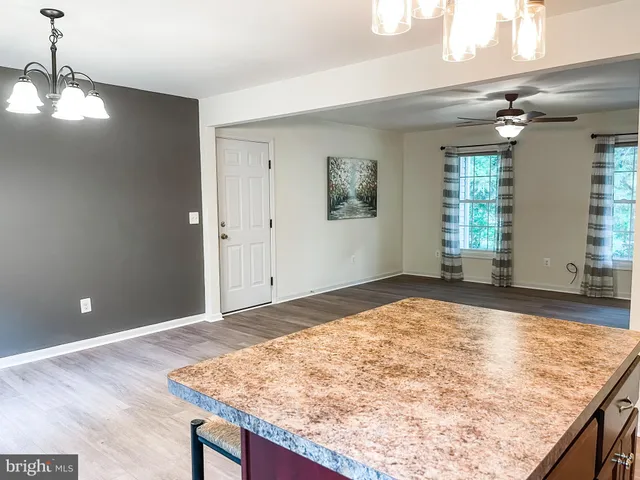 a kitchen with stainless steel appliances granite countertop a refrigerator a sink a stove a microwave and wooden cabinets