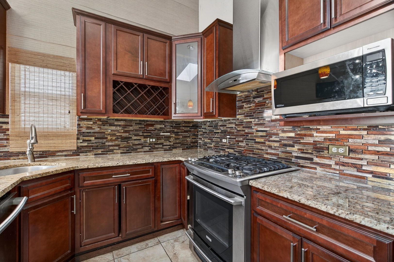 3015 140th Place Blue Island, IL 60406 - Photo 8 of 22 a kitchen with stainless steel appliances granite countertop a sink stove and cabinets