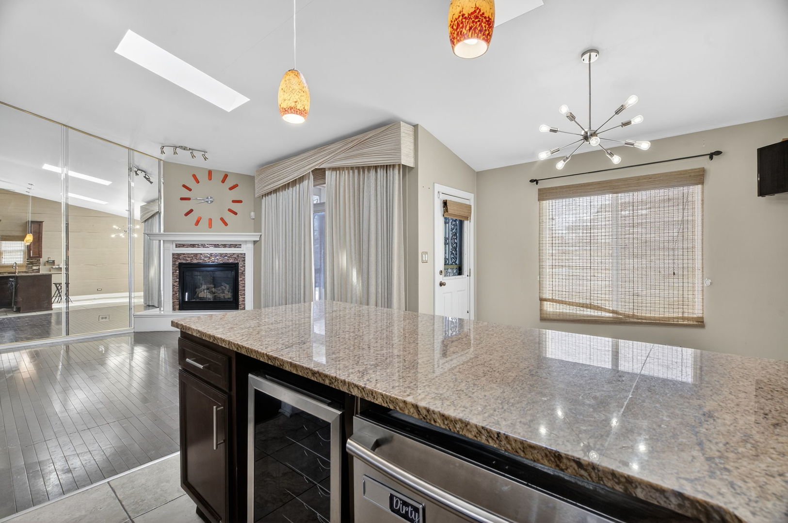 3015 140th Place Blue Island, IL 60406 - Photo 9 of 22 a open kitchen with granite countertop a sink dishwasher a fireplace with wooden floor