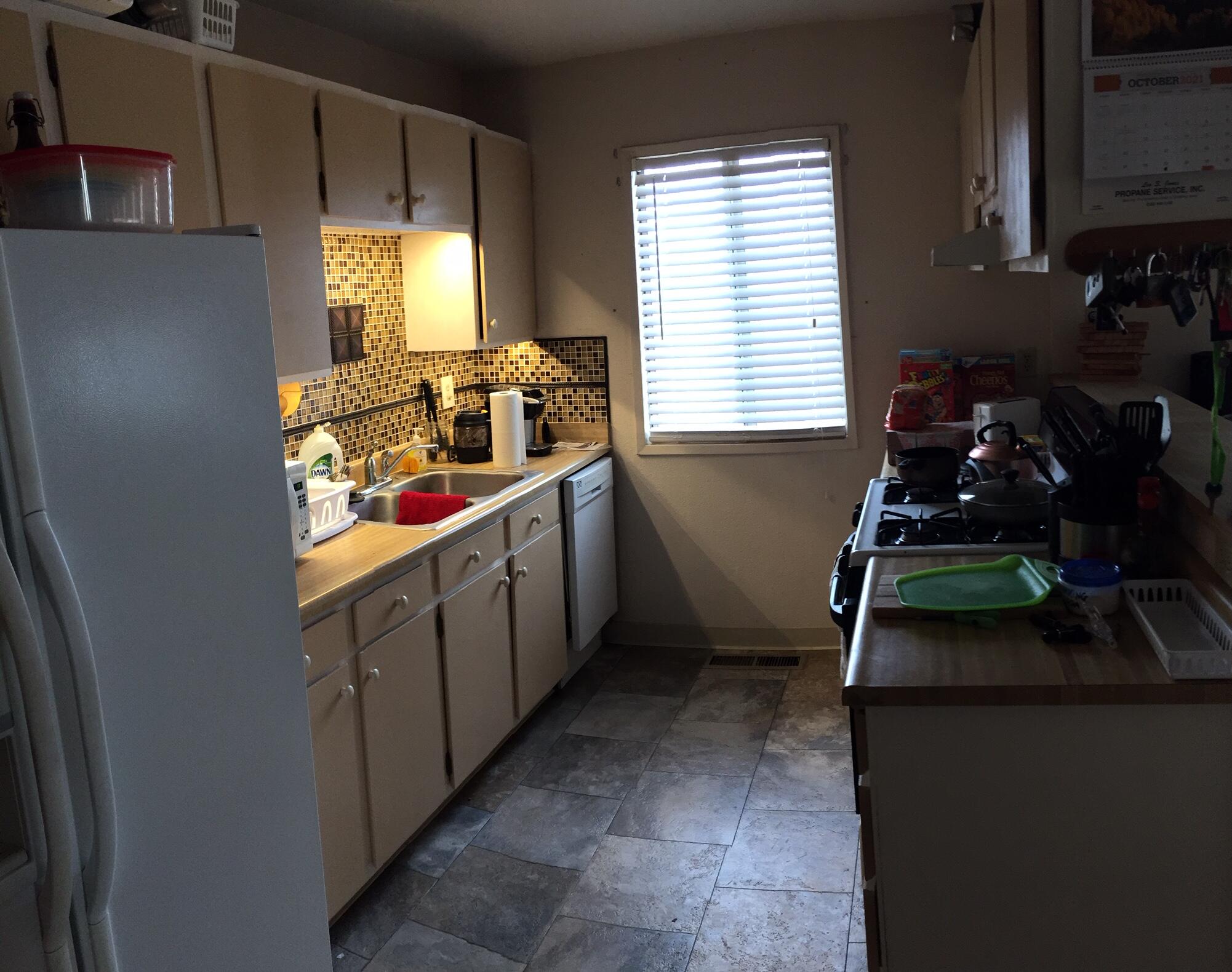 20678 Roff Way Burney, CA 96013 - Photo 3 of 12 a kitchen with white cabinets and window