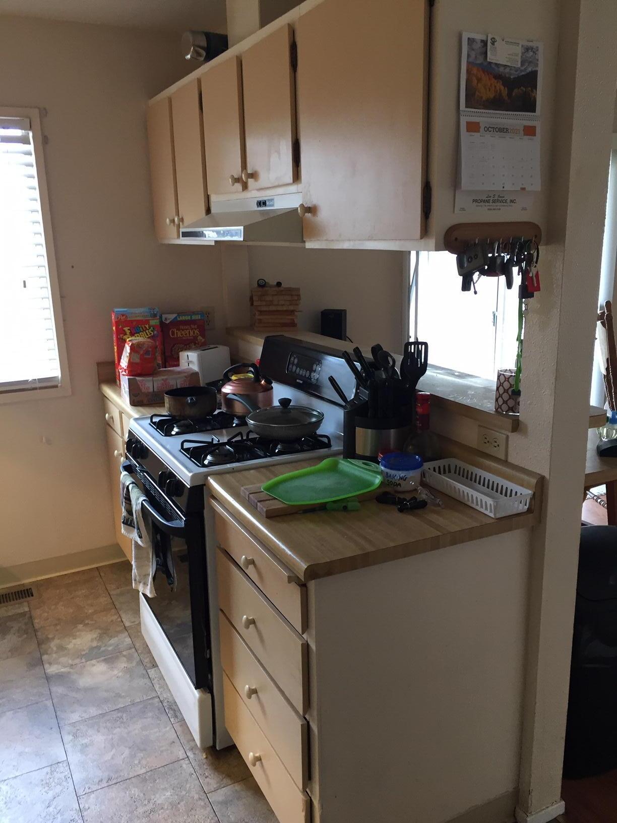20678 Roff Way Burney, CA 96013 - Photo 7 of 12 a kitchen with stainless steel appliances granite countertop a stove and a cabinets
