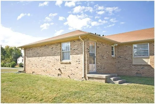 a view of a with brick wall and a yard