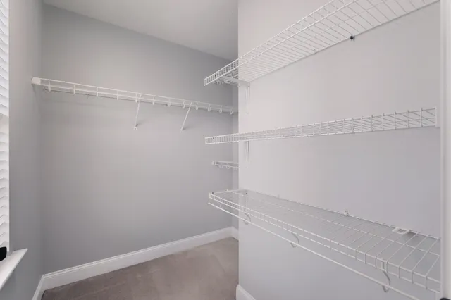 a bathroom with a granite countertop sink two mirror and shower
