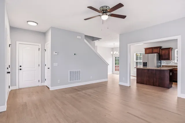 a view of a kitchen with a sink and a large window