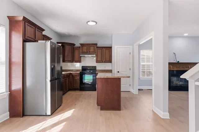 a kitchen with stainless steel appliances a refrigerator and a stove