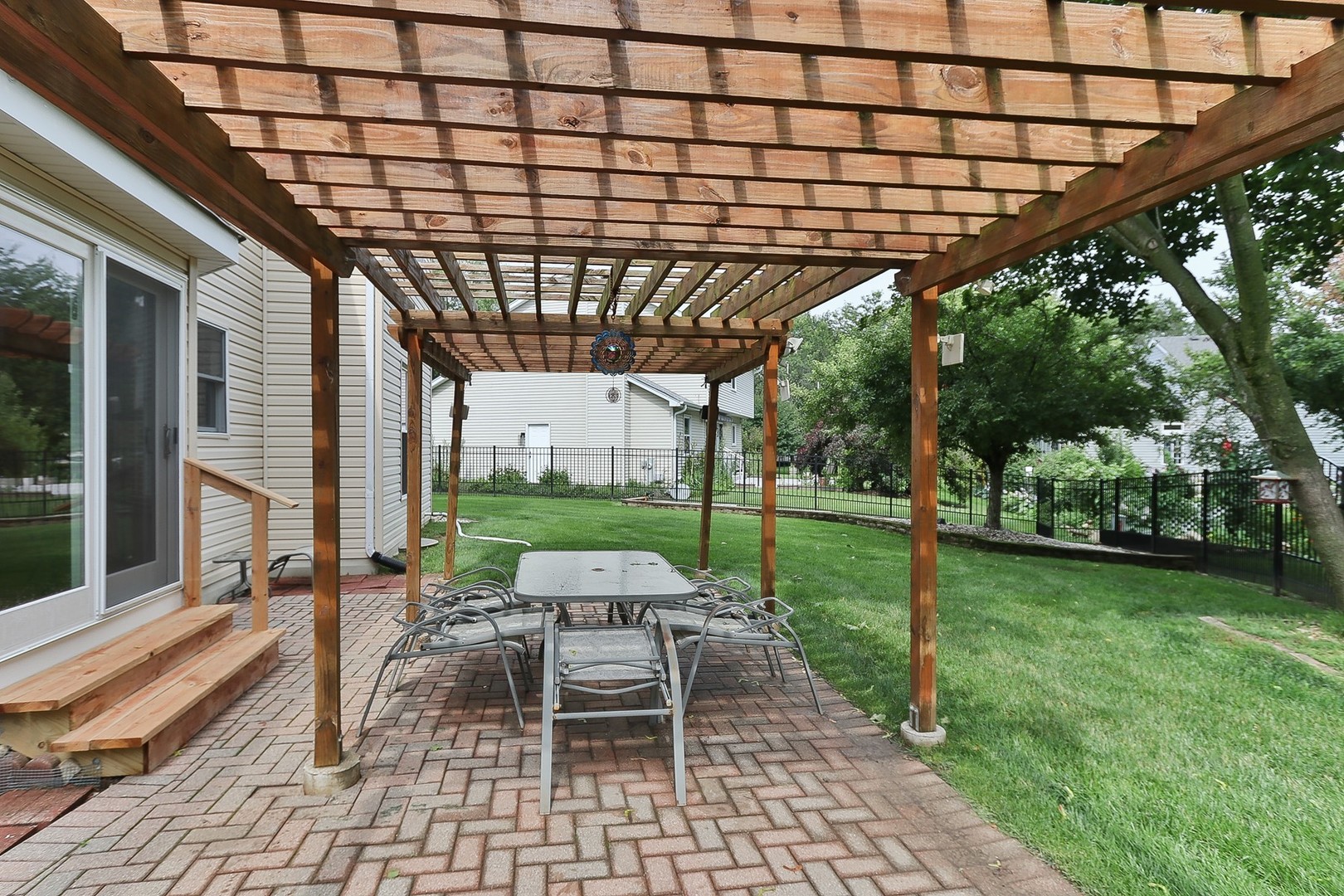 731 Laurel Lane Cary, IL 60013 - Photo 2 of 6 a patio with a patio table and chairs