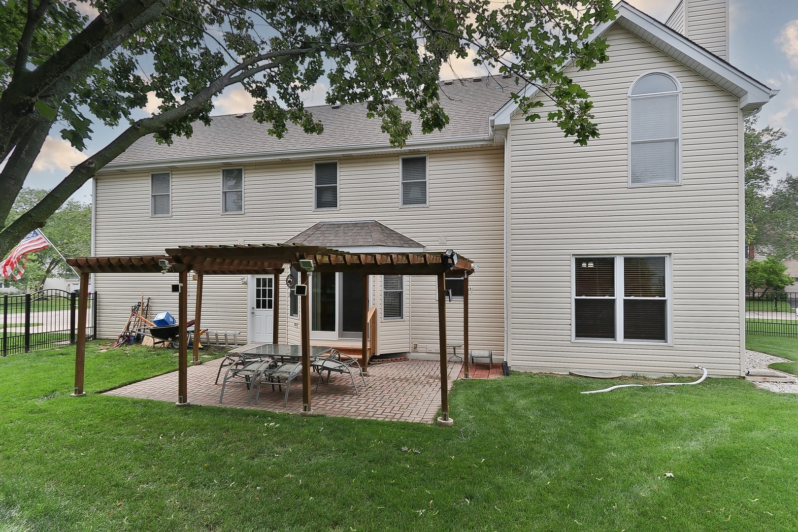 731 Laurel Lane Cary, IL 60013 - Photo 3 of 6 a patio with a table and chairs and a fire pit