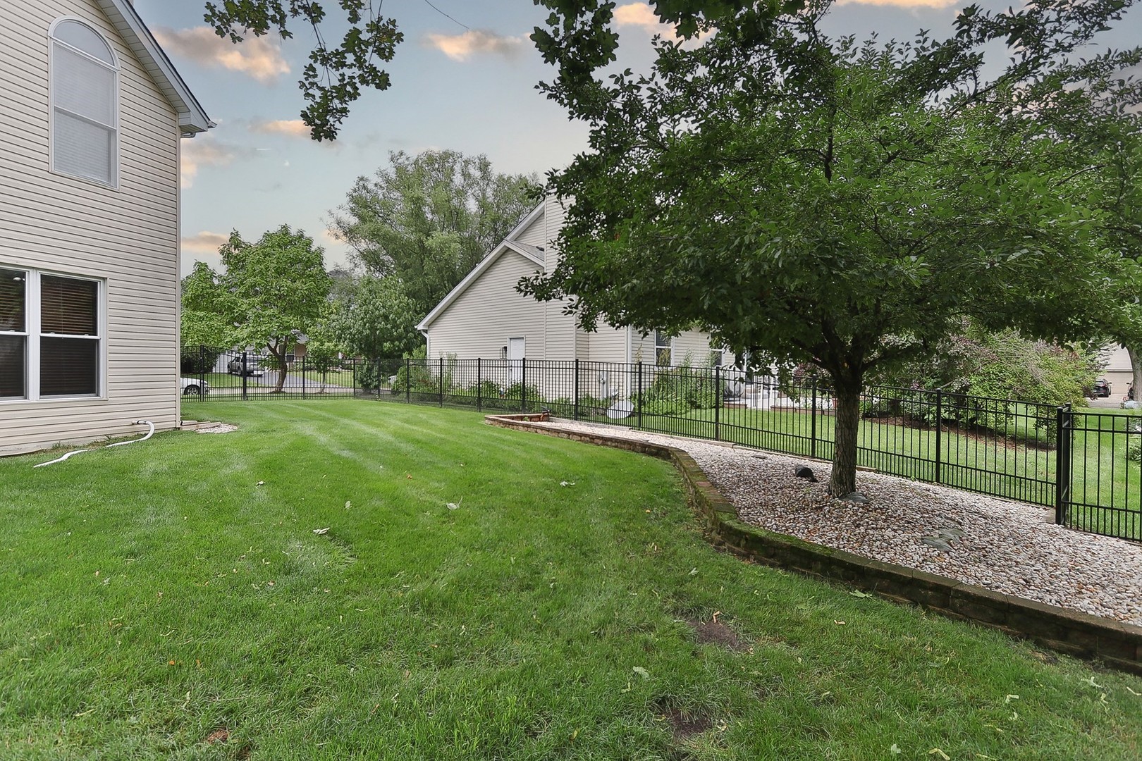 731 Laurel Lane Cary, IL 60013 - Photo 5 of 6 a house with green field in front of it
