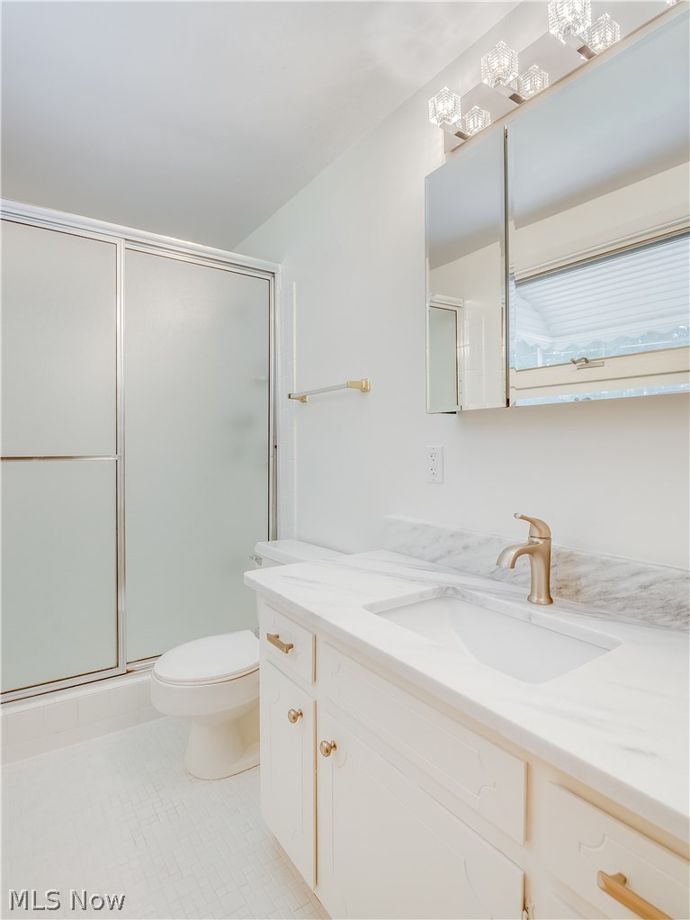 1047 Roland Road Lyndhurst, OH 44124 - Photo 13 of 26 Master Bathroom with new Granite Countertop, sink, faucet, medicine cabinet, and vanity light.