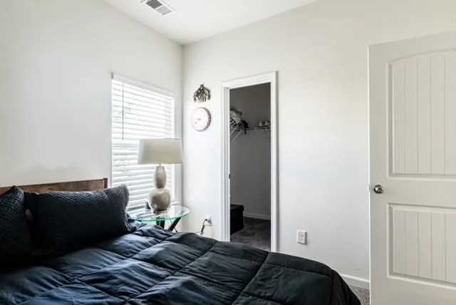 a bathroom with a granite countertop toilet sink and mirror