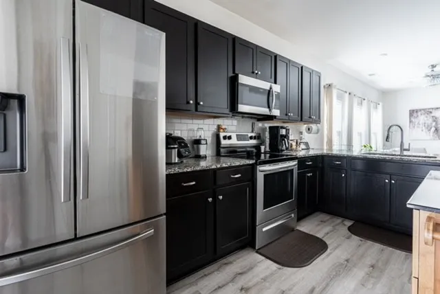 a kitchen with a sink stove and refrigerator