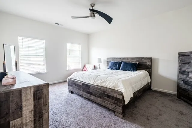 a bedroom with a bed and a table