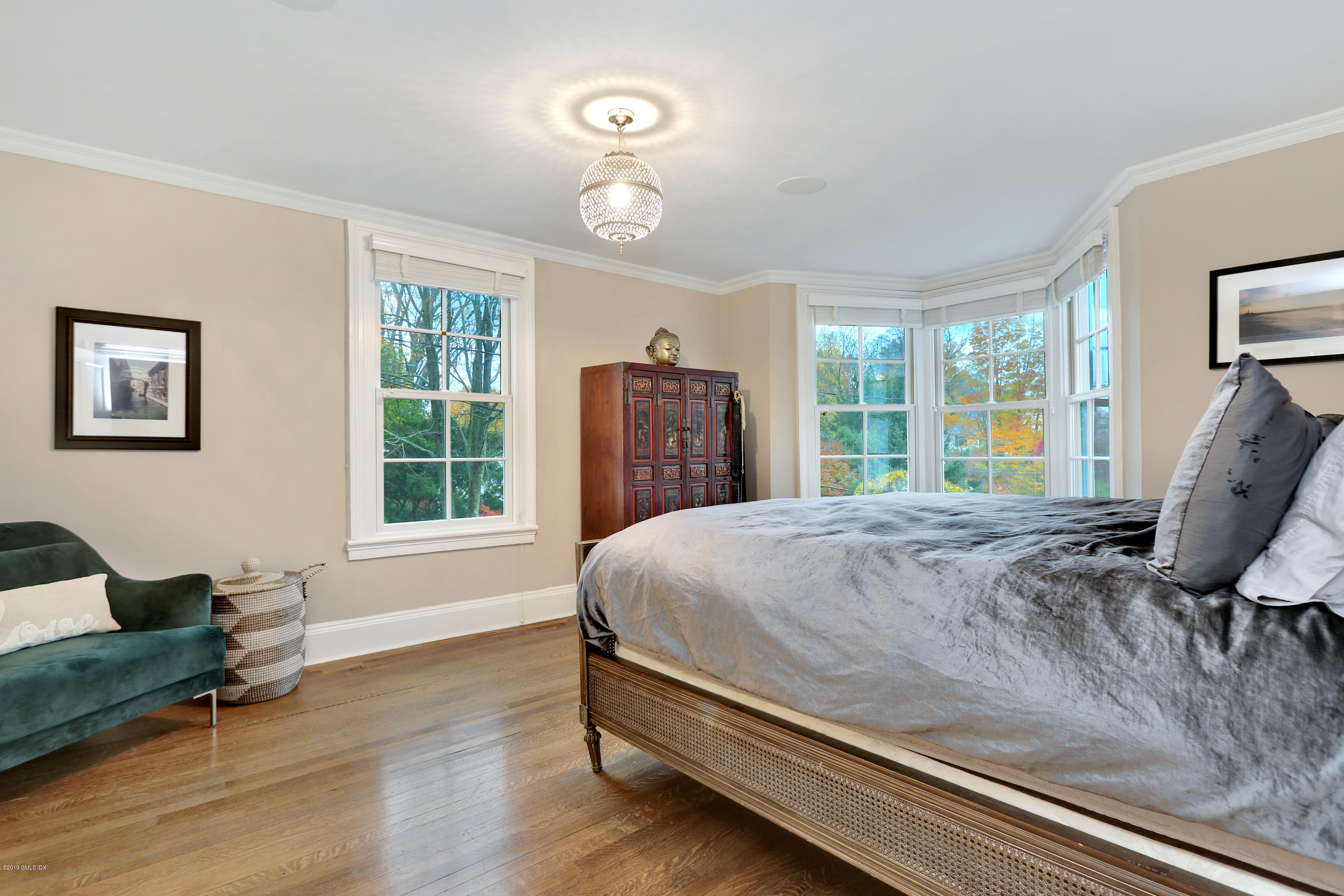 20 Lockwood Road Riverside, CT 06878 - Photo 14 of 27 a bed sitting in a spacious bedroom next to a window and a larger window