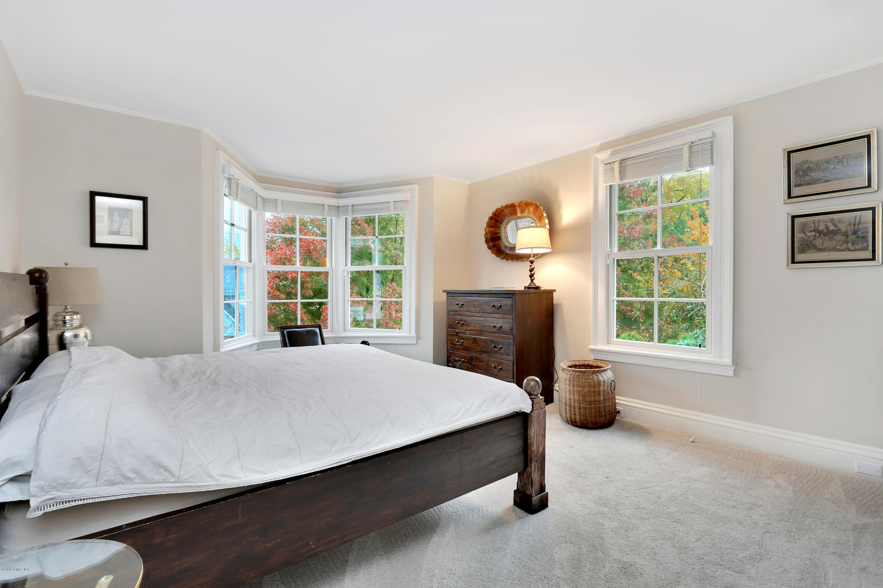 20 Lockwood Road Riverside, CT 06878 - Photo 19 of 27 a bed sitting in a spacious bedroom next to a window and a larger closet