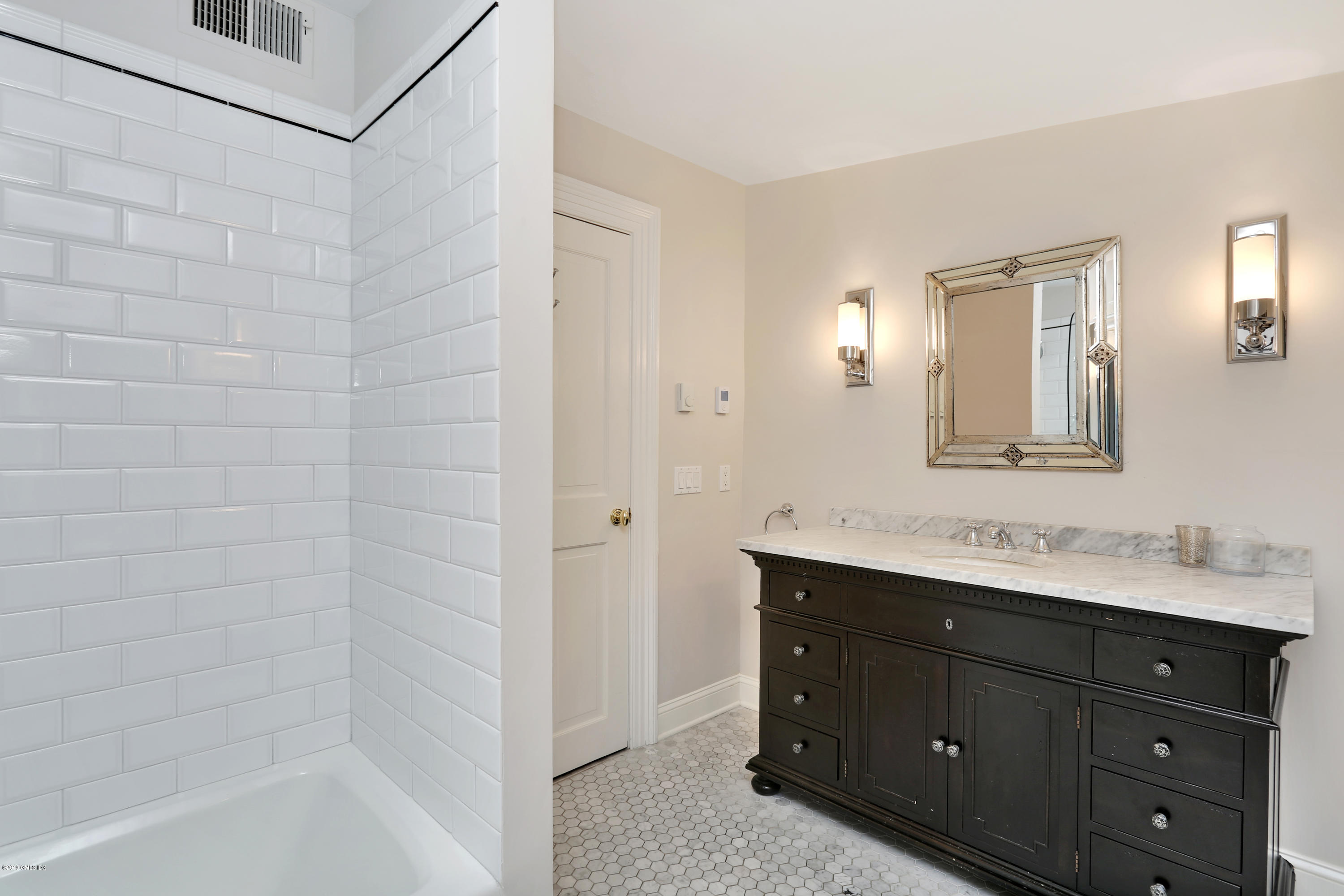 20 Lockwood Road Riverside, CT 06878 - Photo 21 of 27 a bathroom with a sink mirror and a shower