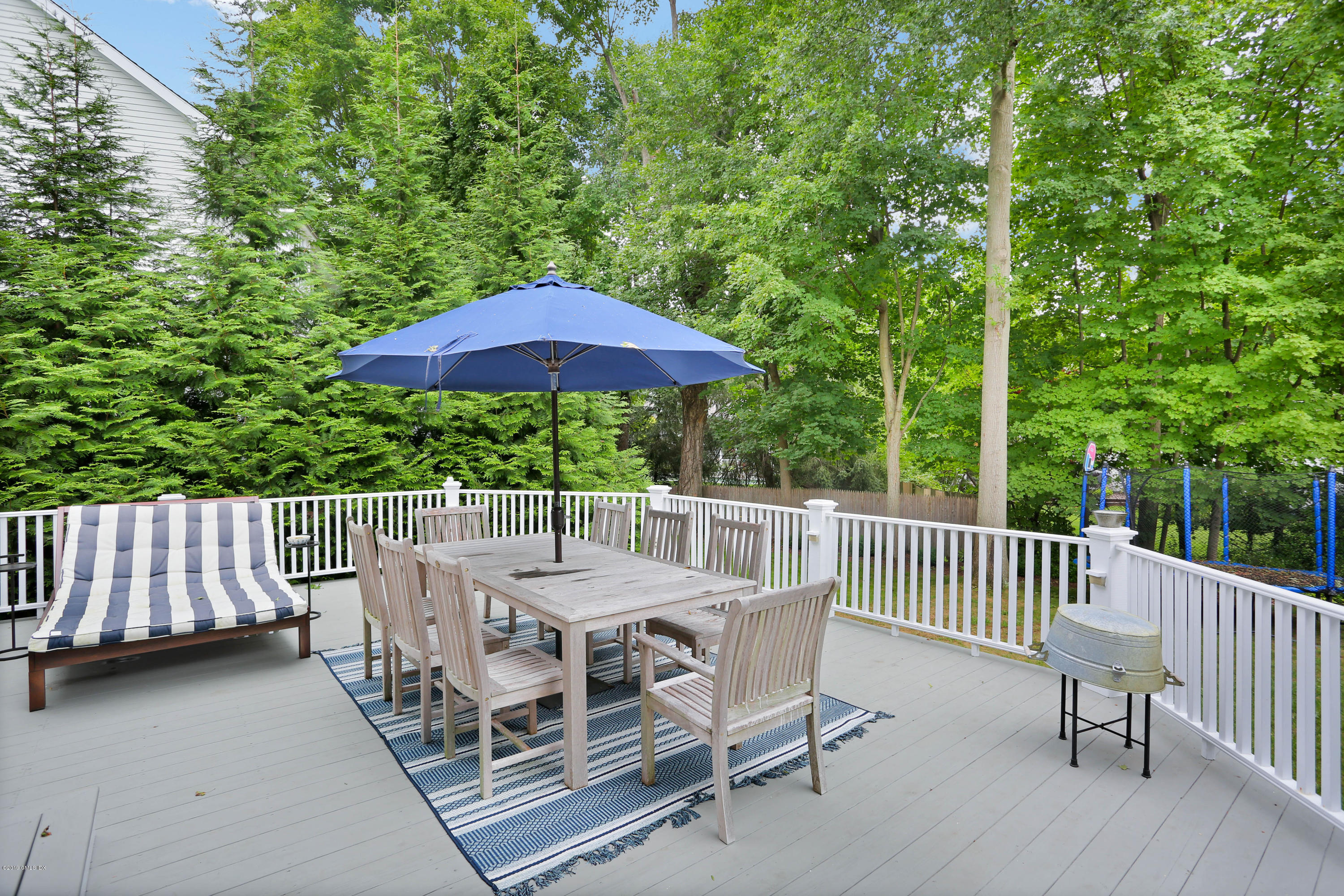 20 Lockwood Road Riverside, CT 06878 - Photo 24 of 27 a view of a chairs and table in the back yard