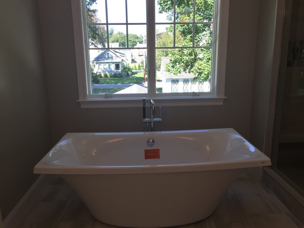 5 Thomas Road Wellesley, MA 02482 - Photo 22 of 29 a bath tub sitting in a bathroom next to a window