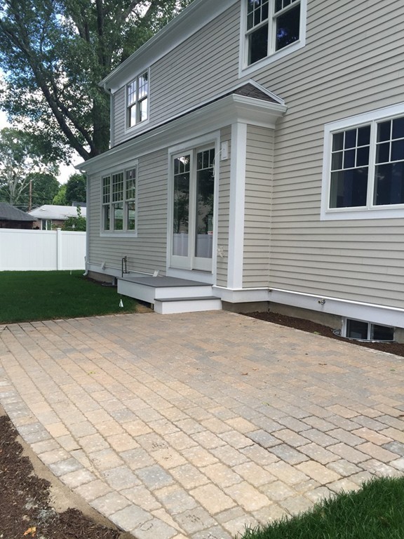 5 Thomas Road Wellesley, MA 02482 - Photo 5 of 29 a front view of a house with a yard
