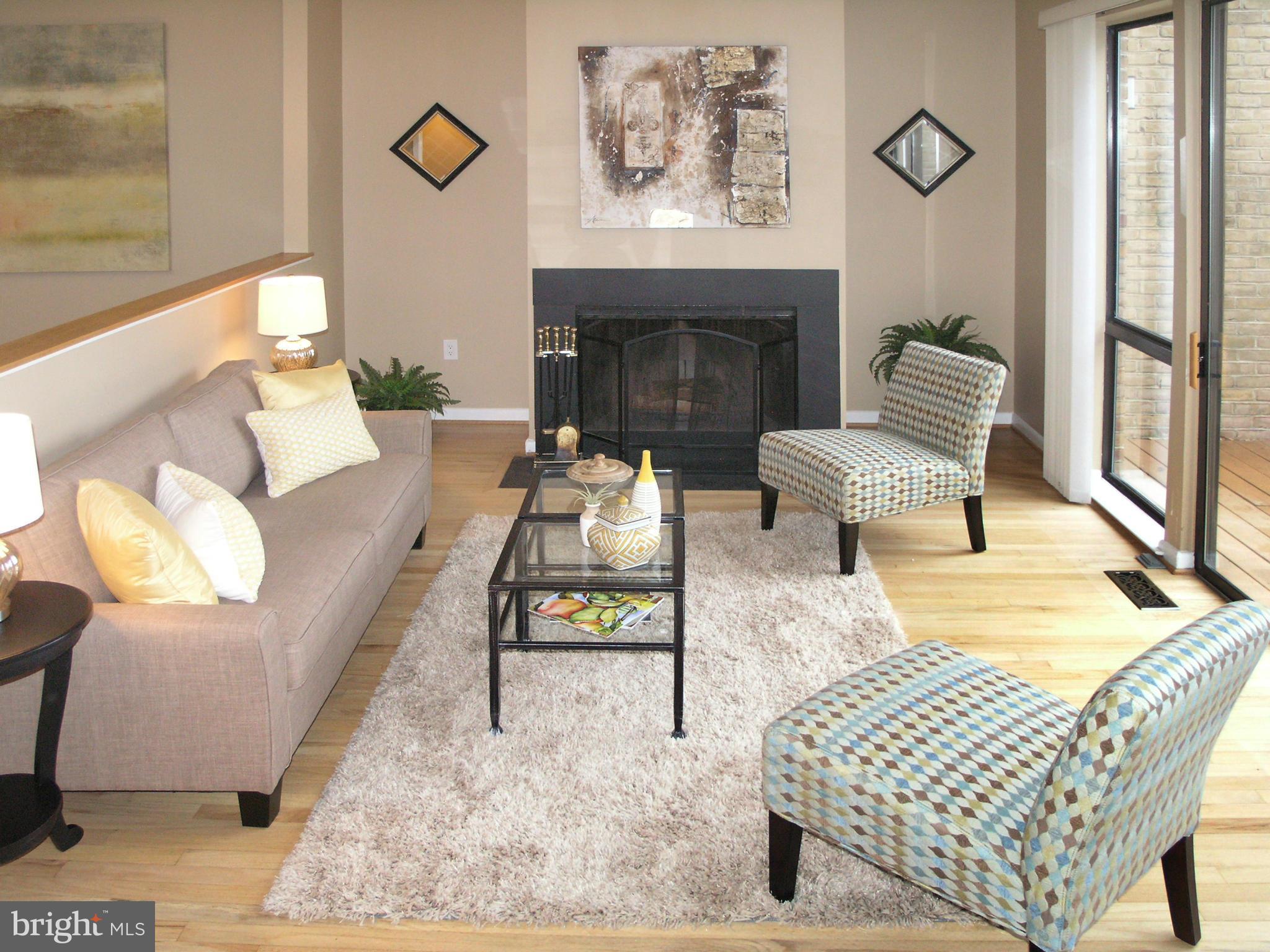 11204 Lagoon Lane Reston, VA 20191 - Photo 11 of 30 a living room with furniture and a fireplace