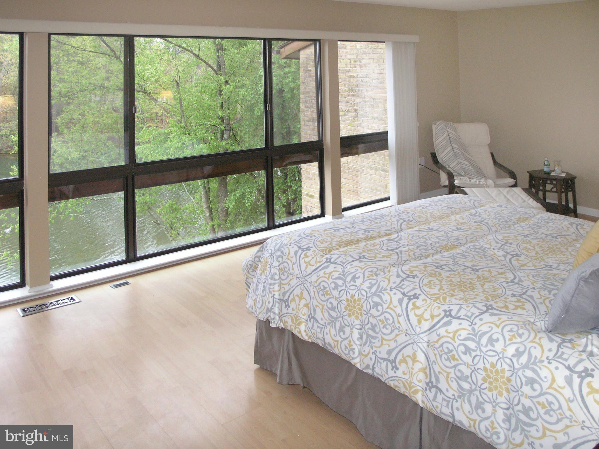 11204 Lagoon Lane Reston, VA 20191 - Photo 16 of 30 a large bed sitting in a bedroom next to a large window