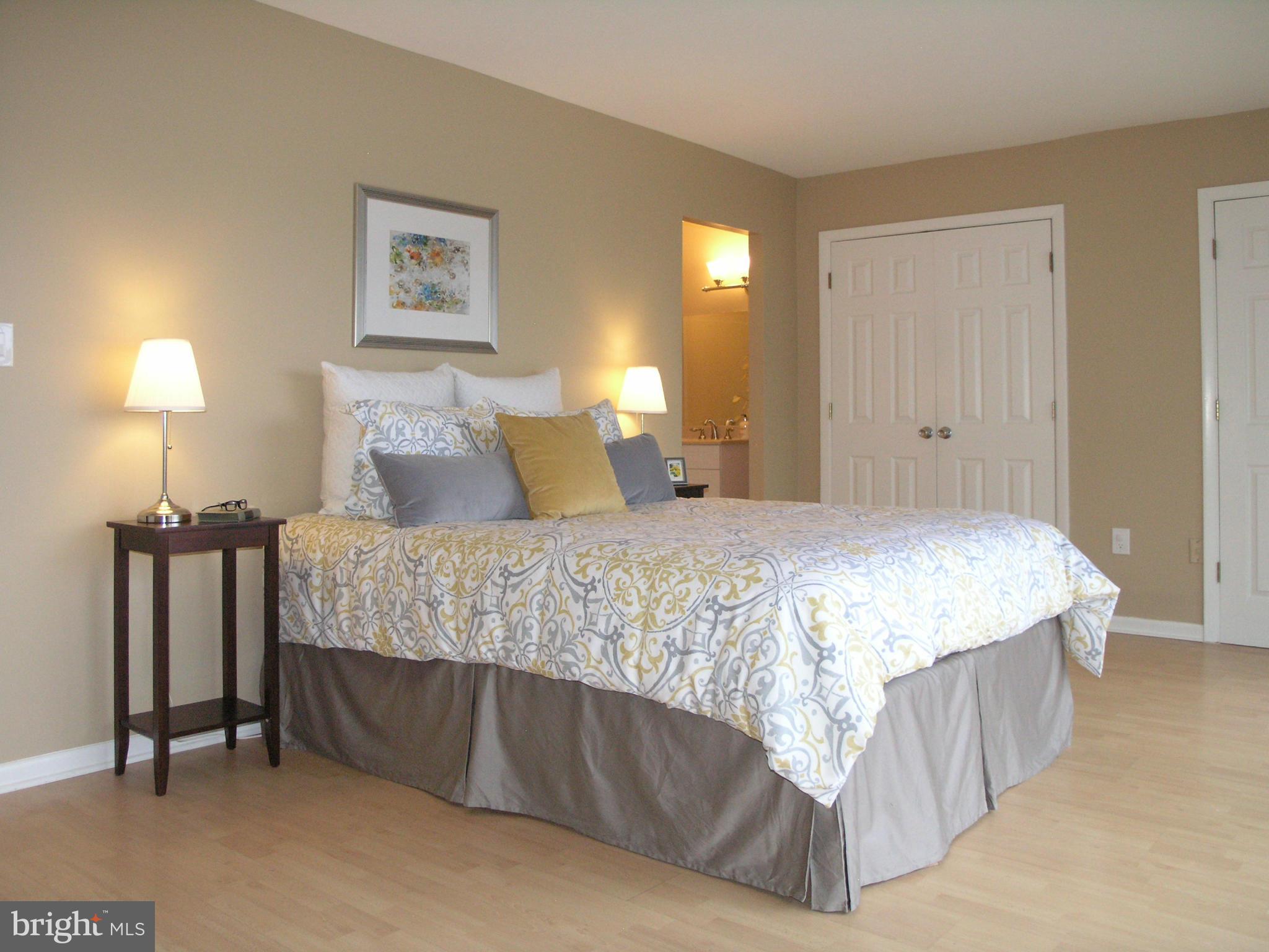 11204 Lagoon Lane Reston, VA 20191 - Photo 17 of 30 a bedroom with a bed and a night stand