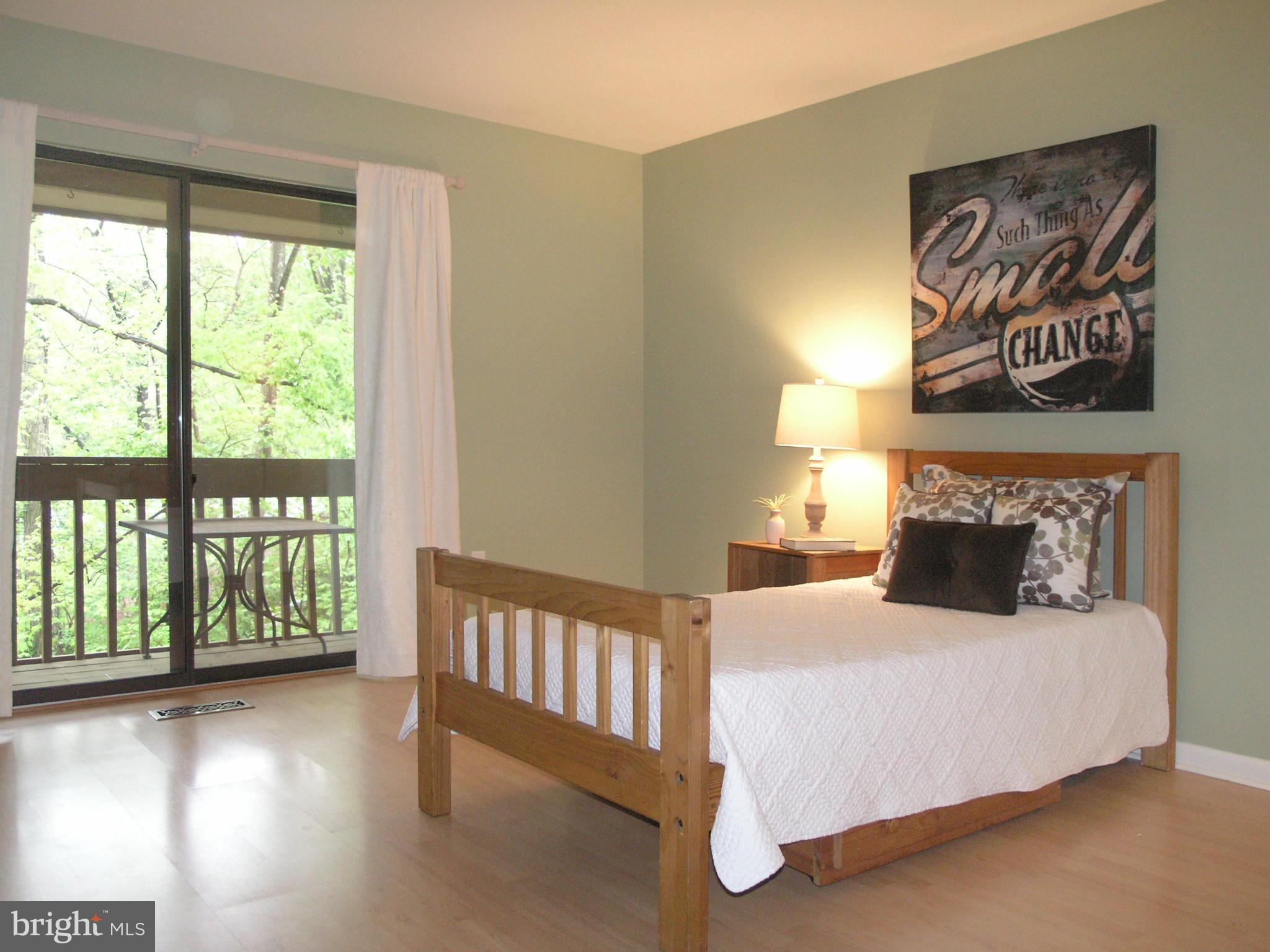 11204 Lagoon Lane Reston, VA 20191 - Photo 19 of 30 a bedroom with a bed and a large window