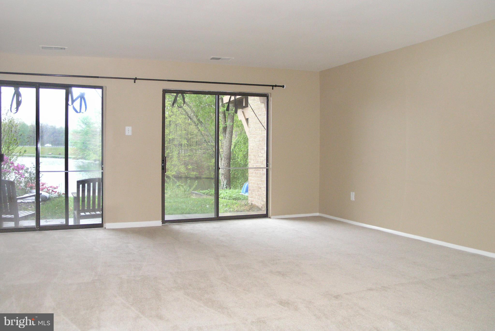 11204 Lagoon Lane Reston, VA 20191 - Photo 24 of 30 a view of an empty room with wooden floor and a window