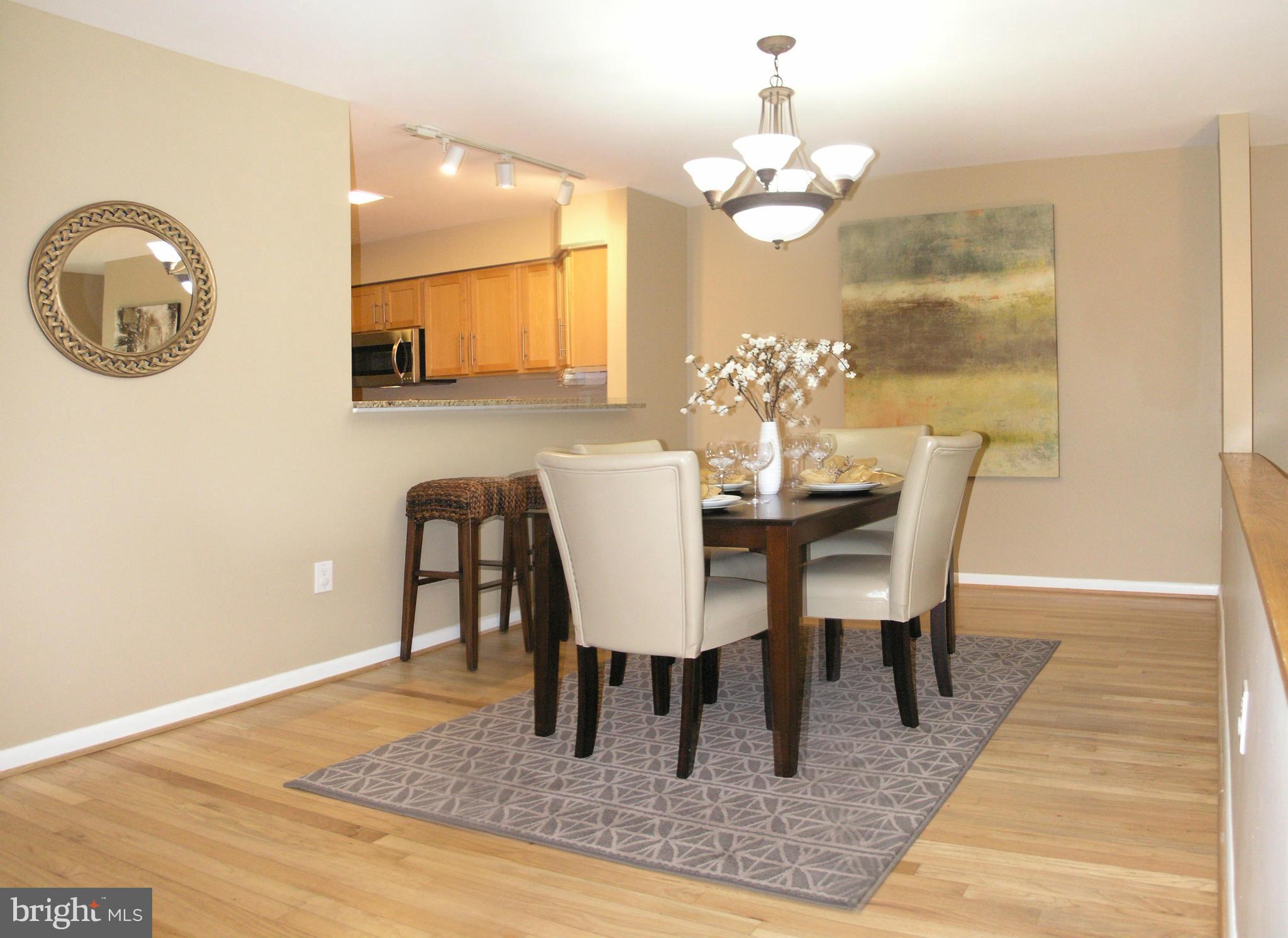 11204 Lagoon Lane Reston, VA 20191 - Photo 9 of 30 a view of a dining room with furniture and chandelier