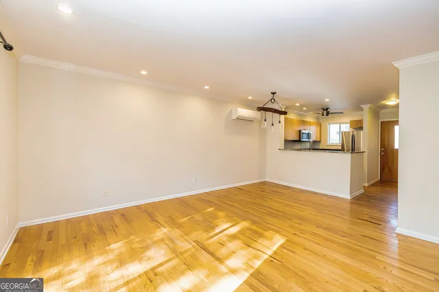 a view of a hallway with wooden floor