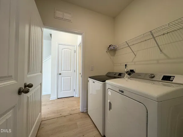 a view of storage and utility room with washer and dryer