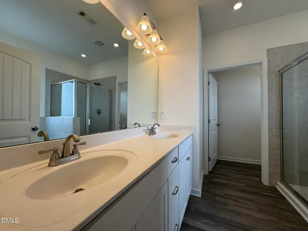 a bathroom with a double vanity sink and a mirror