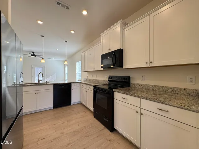 a large kitchen with cabinets