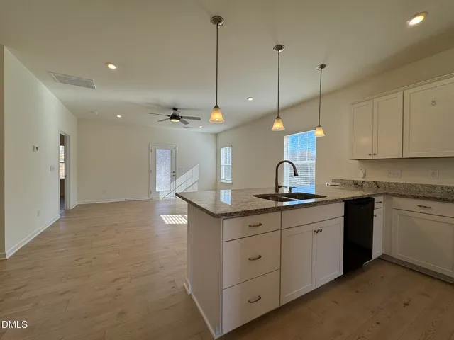 a kitchen with kitchen island a sink stainless steel appliances and cabinets