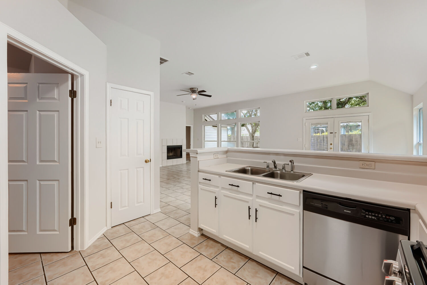 119 Stephen Lane Georgetown, TX 78626 - Photo 6 of 32 A well-appointed kitchen features a double sink and stainless steel dishwasher, opening to a spacious living area with abundant natural light filtered by the shade trees in your private back yard.