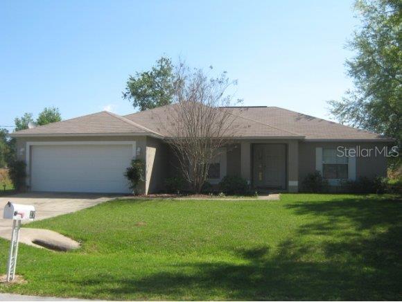 27 Pecan Course Loop Ocala, FL 34472 - Photo 1 of 1 a front view of a house with a yard and garage