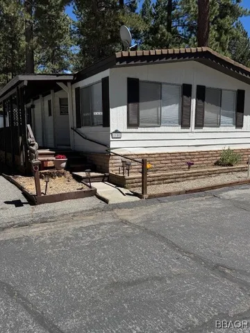 a view of house with backyard and furniture