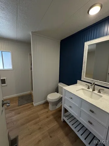 a bathroom with a sink toilet and mirror