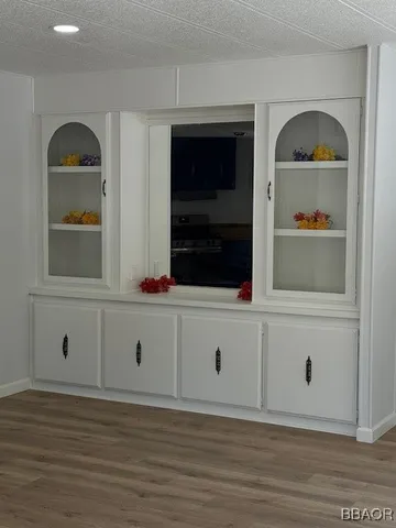 a view of white cabinet with wooden floor