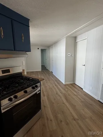 a kitchen with wooden cabinets and a stove top oven