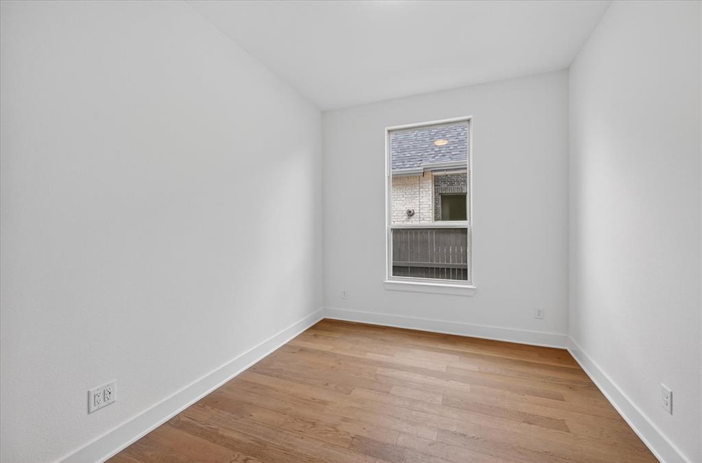 3776 Jane Street Venus, TX 76084 - Photo 19 of 25 a view of an empty room with wooden floor and a window