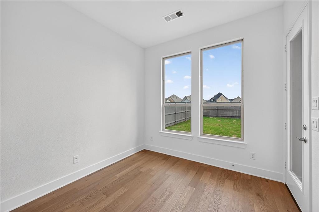 3776 Jane Street Venus, TX 76084 - Photo 23 of 25 an empty room with wooden floor and windows