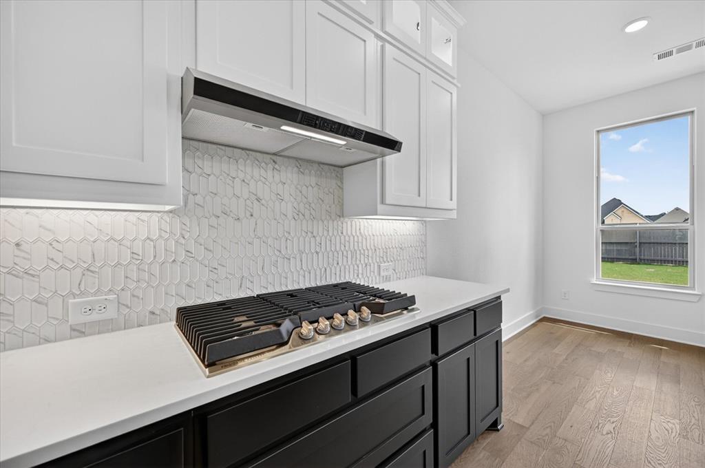 3776 Jane Street Venus, TX 76084 - Photo 5 of 25 a kitchen with a stove and wooden floor