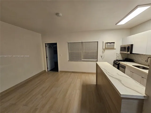 a kitchen with a refrigerator and a stove top oven