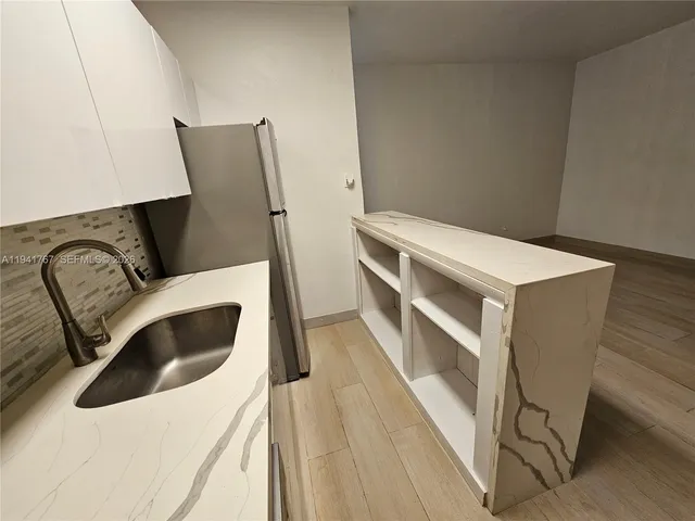 a view of washer and dryer with wooden floor