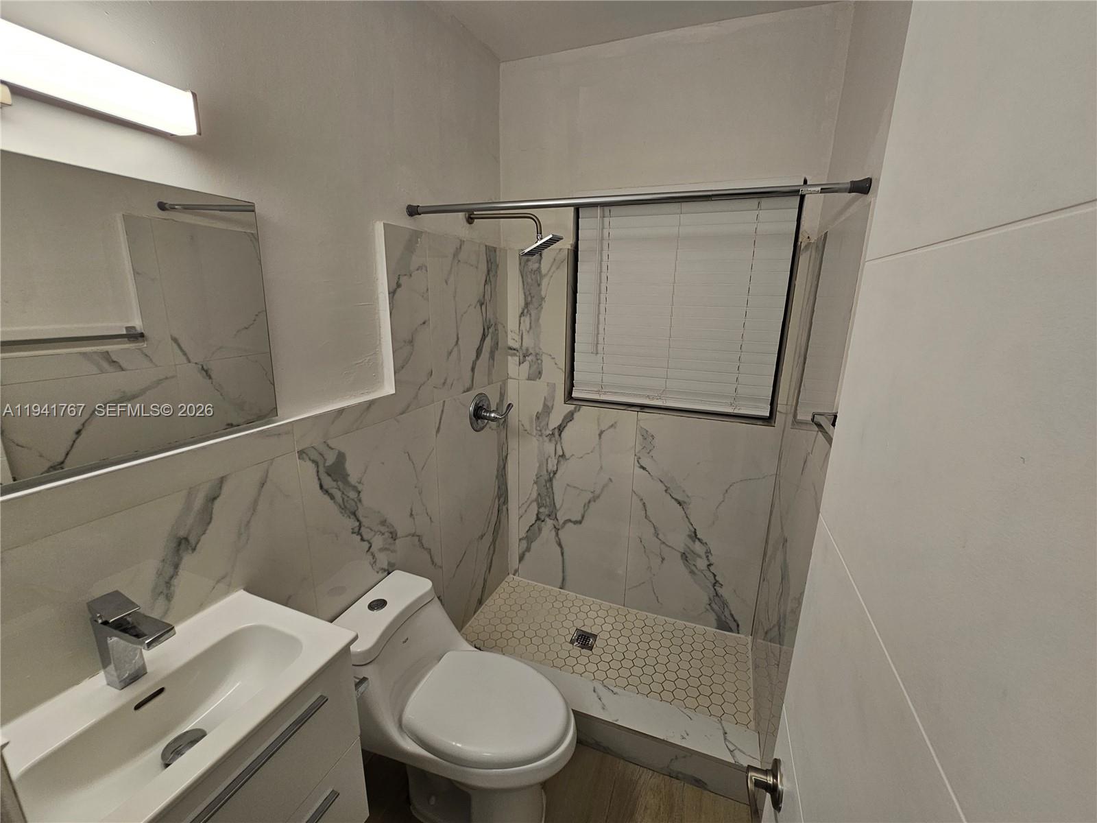 1723 Liberty Street, Unit 4 Hollywood, FL 33020 - Photo 10 of 13 a bathroom with a shower toilet and sink