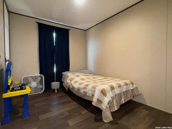 a bed sitting in a bedroom next to a cabinet